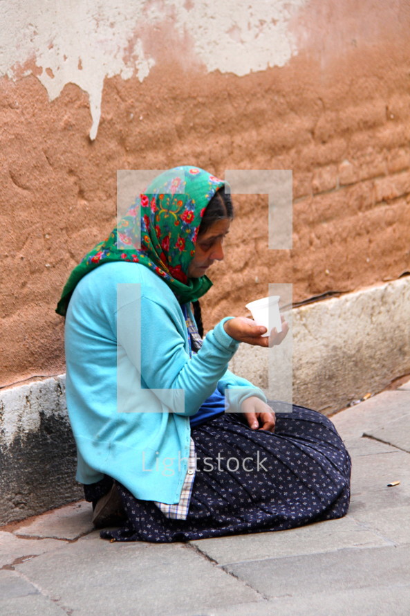 Homeless woman begging on the street