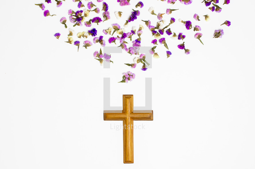 cross and dried purple flowers  