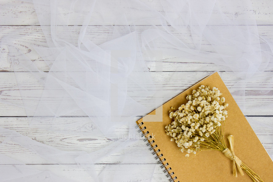 dried flowers on notebook 