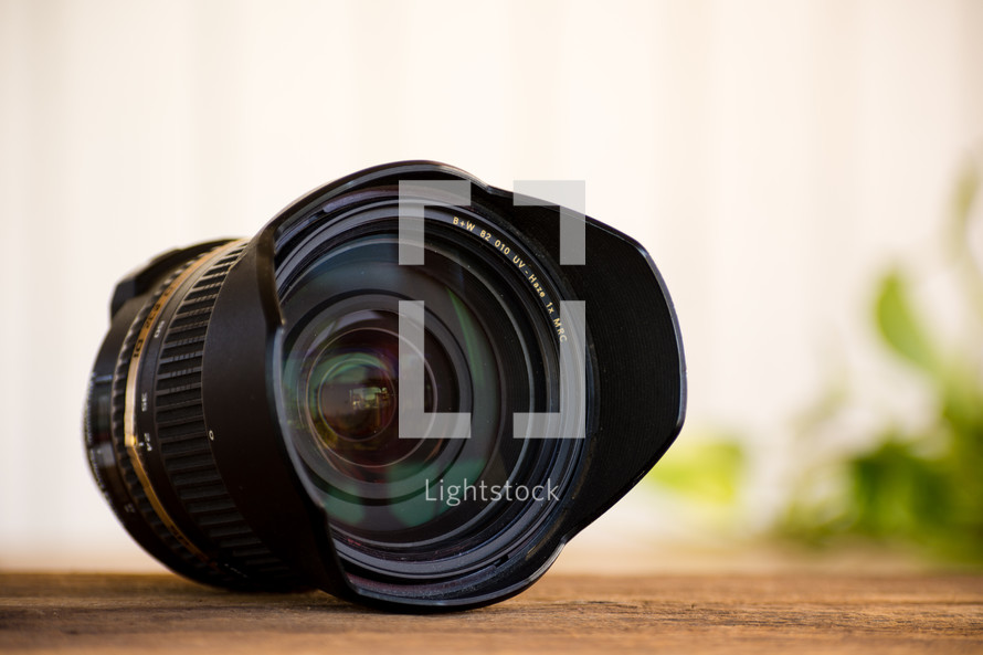 a camera lens on a table with a white background