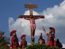 The crucifixion of Jesus - Roman soldiers stand by and mock Jesus as he dies on the cross of Calvary at Golgotha, known as the place of the skull. 