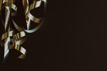 gold streamers on a dark background