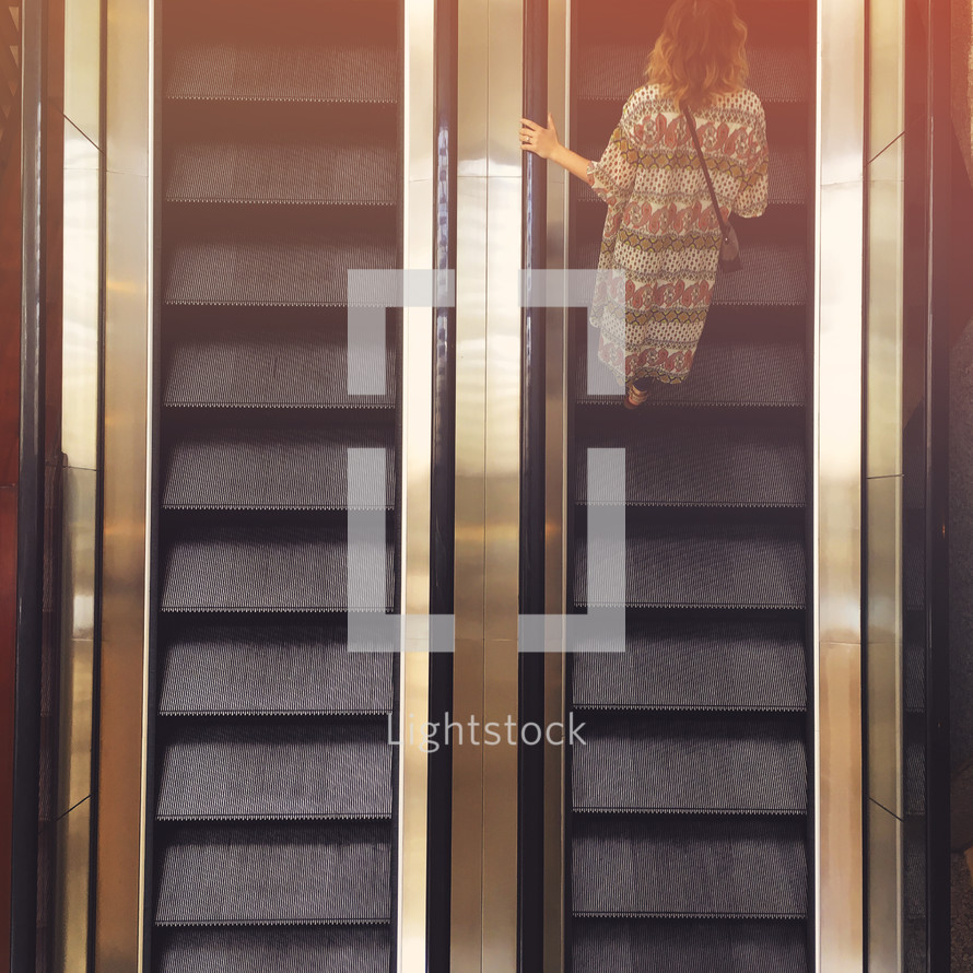a woman on an escalator 