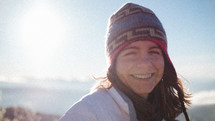 smiling woman in a beanie 