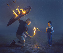 A father protects his child from flaming arrows and uses the fire to cook marshmallows
