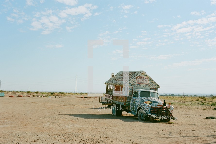 abandoned truck in a desert with Biblical references 