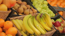 Fresh bananas and  fruits and produce on display in market.