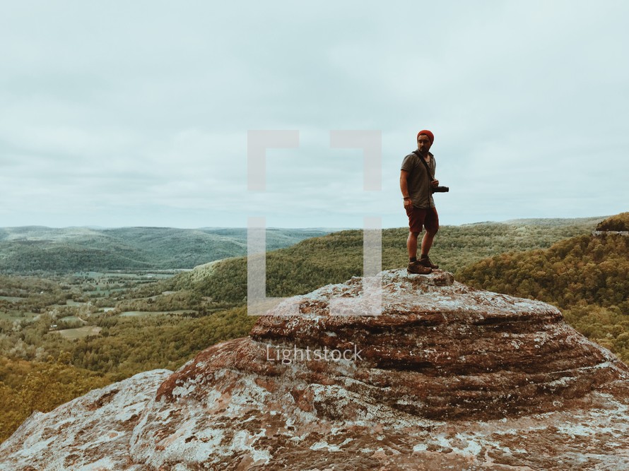 a man standing on a mountain top 