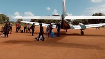 Airplane on dirt runway with resources from mission