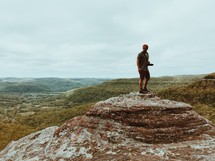 a man standing on a mountain top 