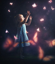 a toddler girl chasing butterflies 