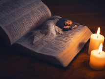 Man sleeps peacefully on the pages of the Bible.