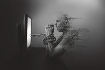 man chained to a computer screen
