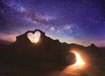 Heart and cross under the night sky
