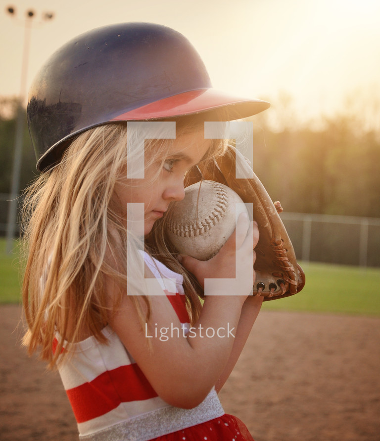 a little girl playing baseball 