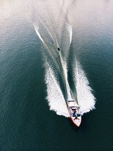 wake of a motor boat with a water skier being pulled behind 