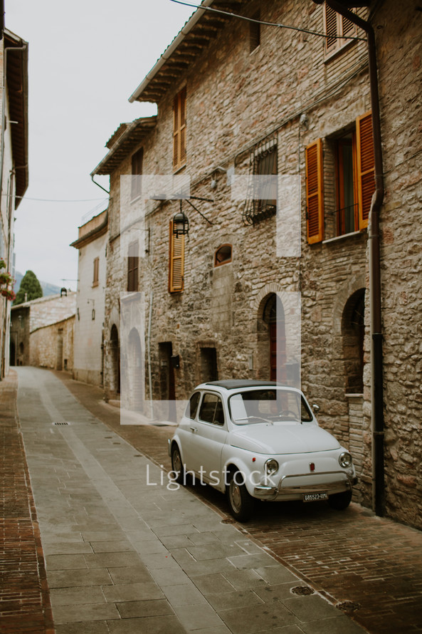 parked car on a narrow village street 