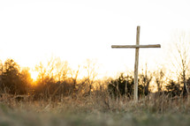 A wooden cross at sunset.