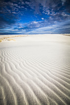 ripples in sand and blue sky