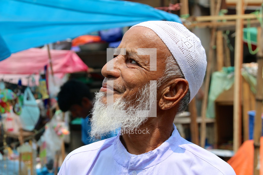 Elderly Muslim man with skull cap and grey beard [For similar, try search Ethnic Face]