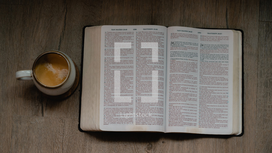 coffee and open Bible on a wood background 