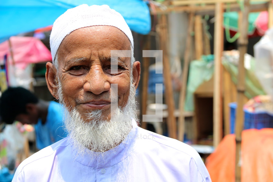 Elderly Muslim man with skull cap and grey beard