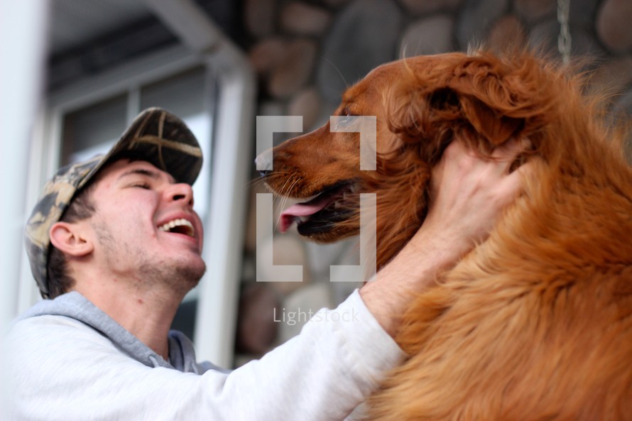 a man petting his dog 