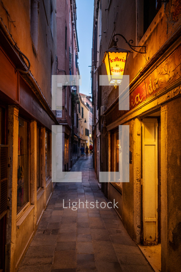 street lamp lighting an alley 