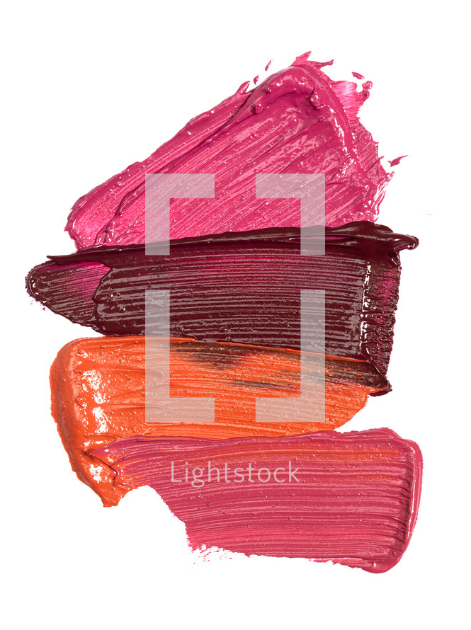Four Shades of Lipstick and Lip Gloss Swatches Isolated on a White Background