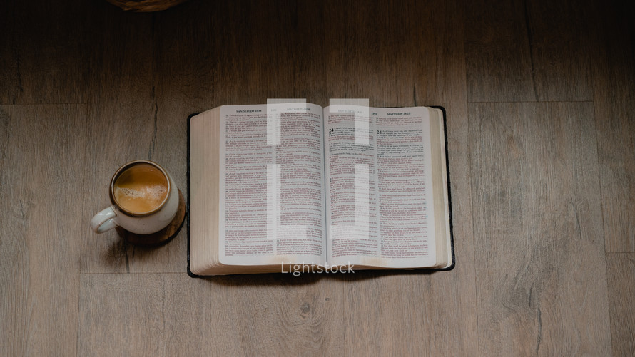 coffee and open Bible on a wood background 