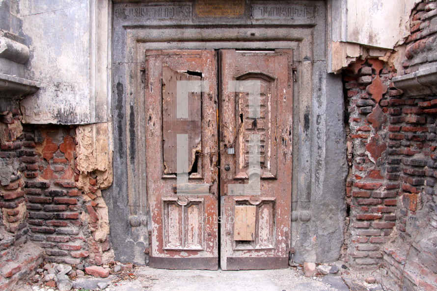 Wooden church doors padlocked and silent after years of persecution and neglect