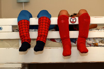 little boys legs hanging off of a bunk bed