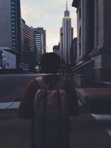 man walking down a city sidewalk