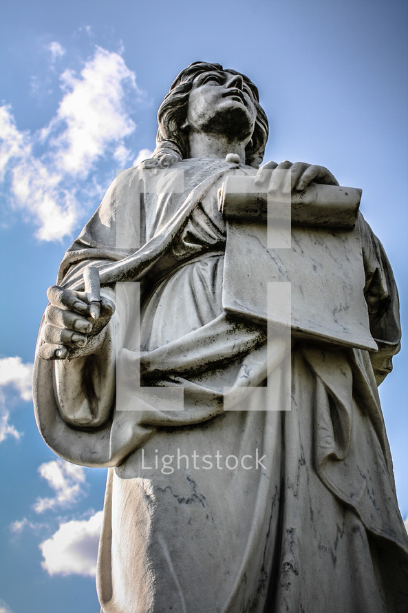 statue holding a scroll