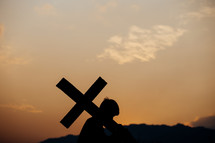 silhouette of a boy with cross 