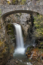A waterfall and a bridge. 