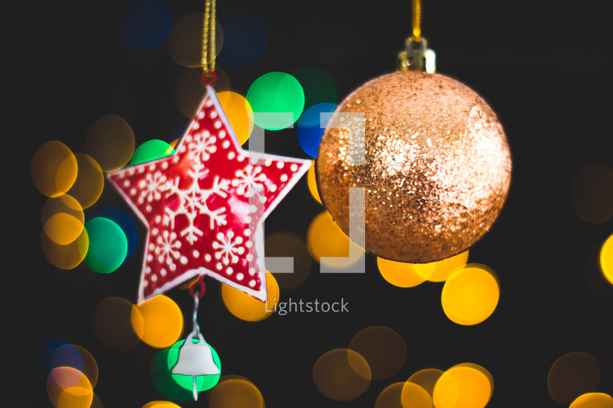 hanging star and ball ornament and bokeh Christmas lights 