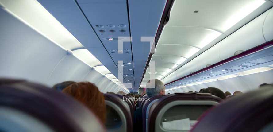Inside an airplane with passengers