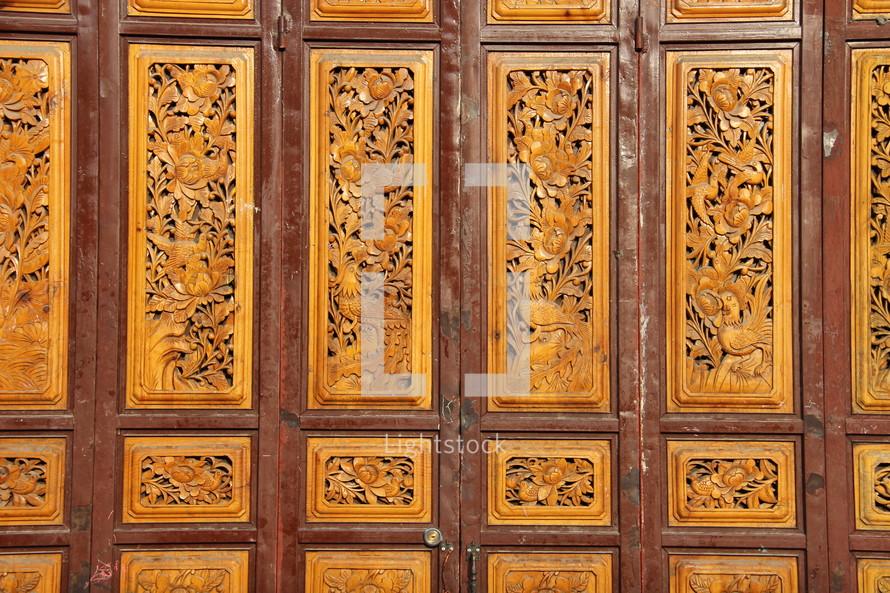 Chinese paneled door with ornate carved detail 