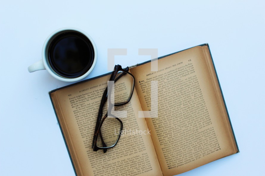 reading glasses on the pages of a book 