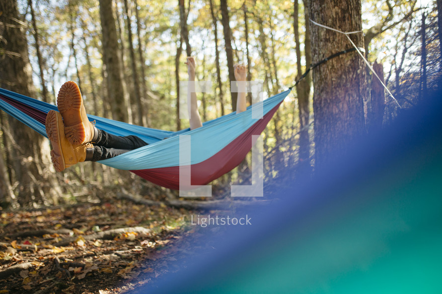 man resting in a hammock in the forest 