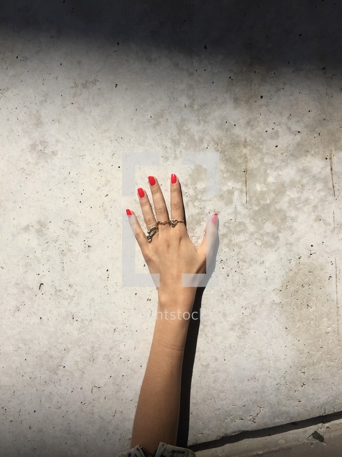 woman's hand, rings, and painted nails 