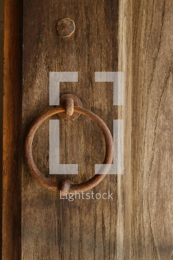 Metal ring on a wood door.