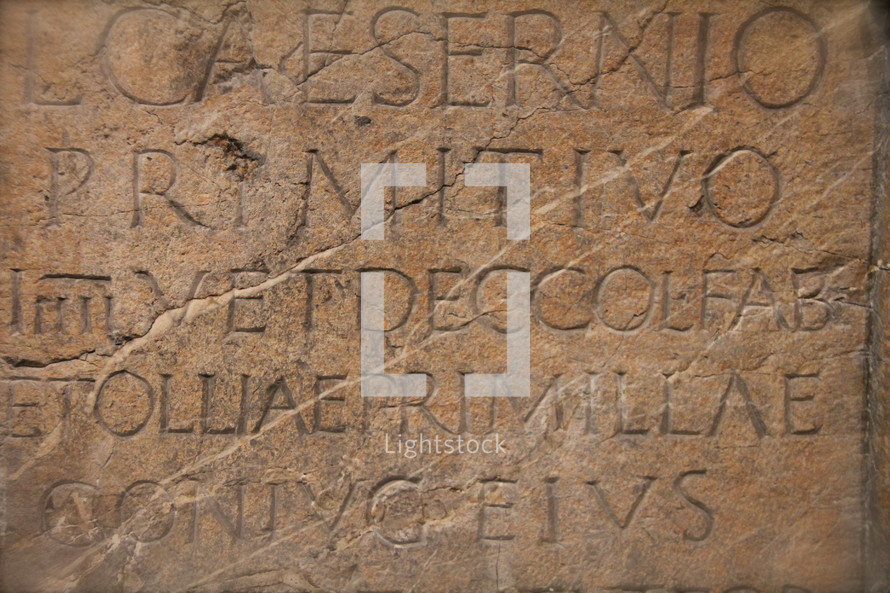 Roman Latin wording carved into ancient monument