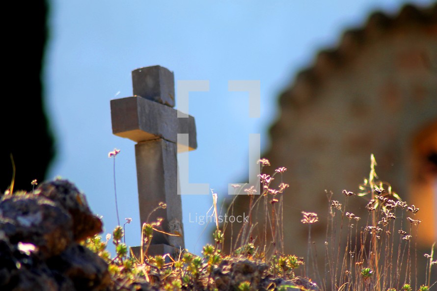 cross grave marker and wildflowers 