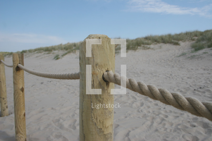 a rope fence on a beach 