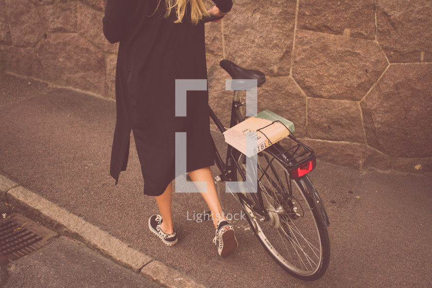 woman pushing a bicycle 