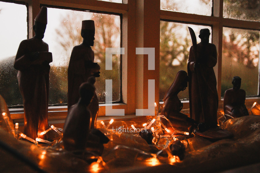 hand carved nativity scene in a window 