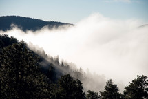 rising clouds and fog in a valley 