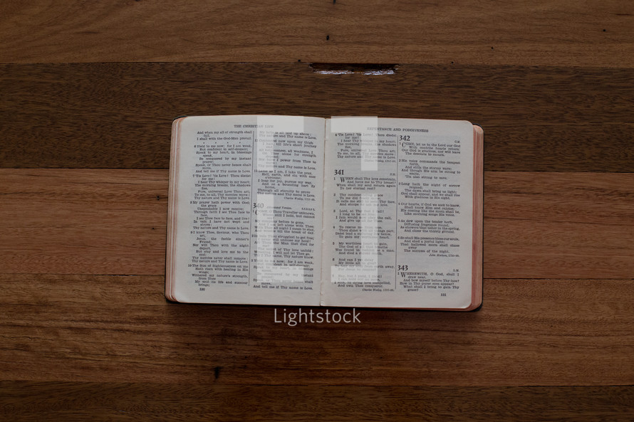"The Christian Life" book on a wooden table, open to the "Repentance and Forgiveness" chapter.